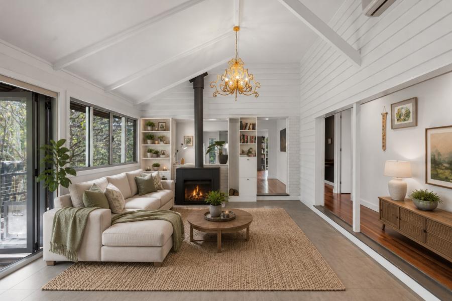 A vaulted-ceiling living room with a fireplace and a cream L-shaped sofa